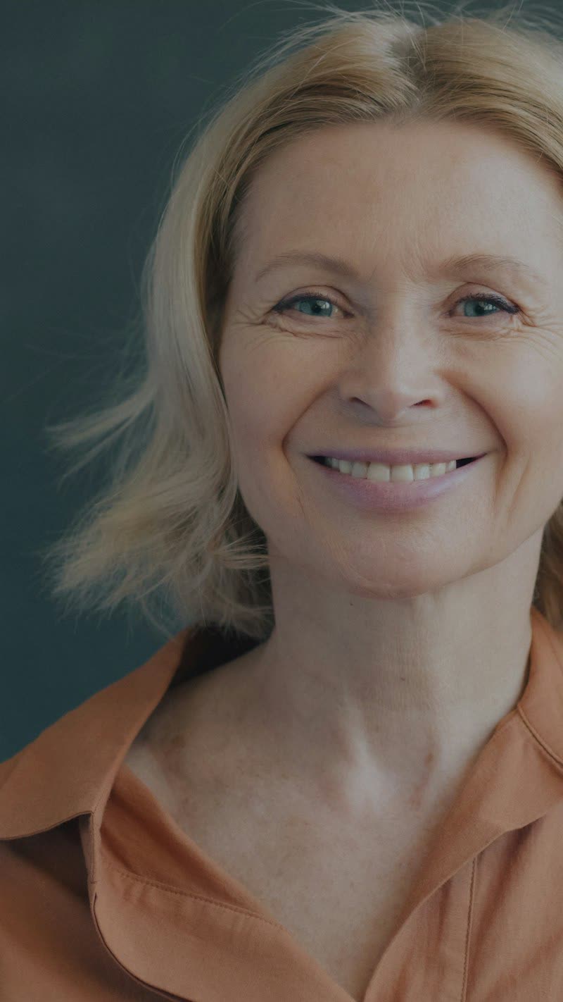 Smiling woman in an orange shirt