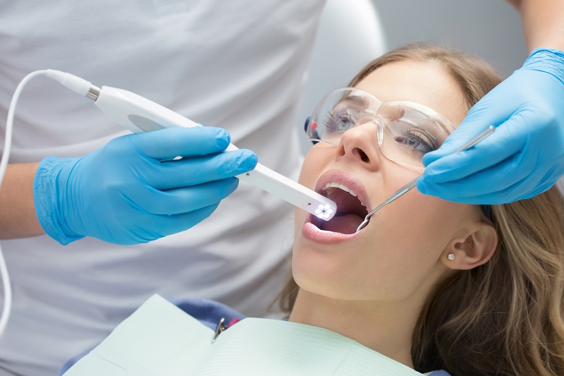 Dentist performing an oral cancer screening